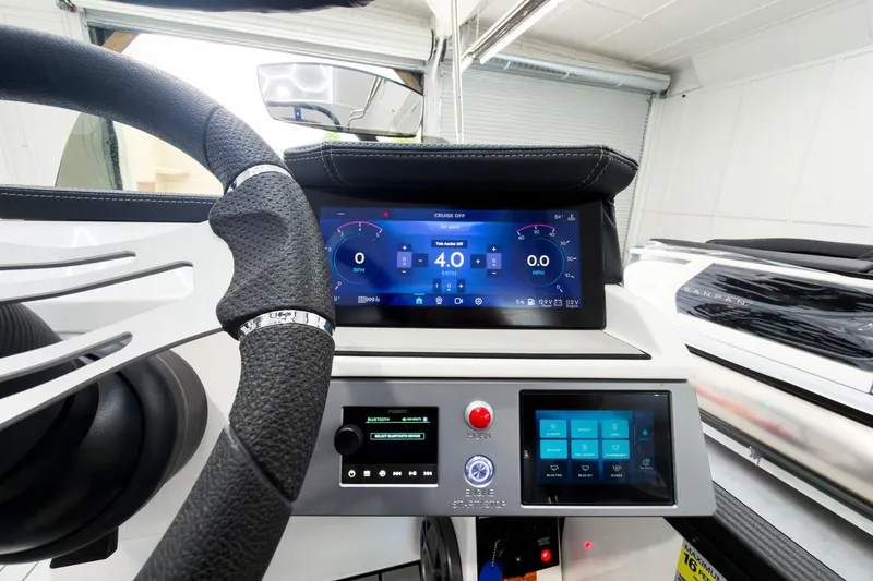 Slide: The Image of 2025 Montara Surf Boss 2.0 SL 25' dashboard with digital displays and steering wheel. - 11