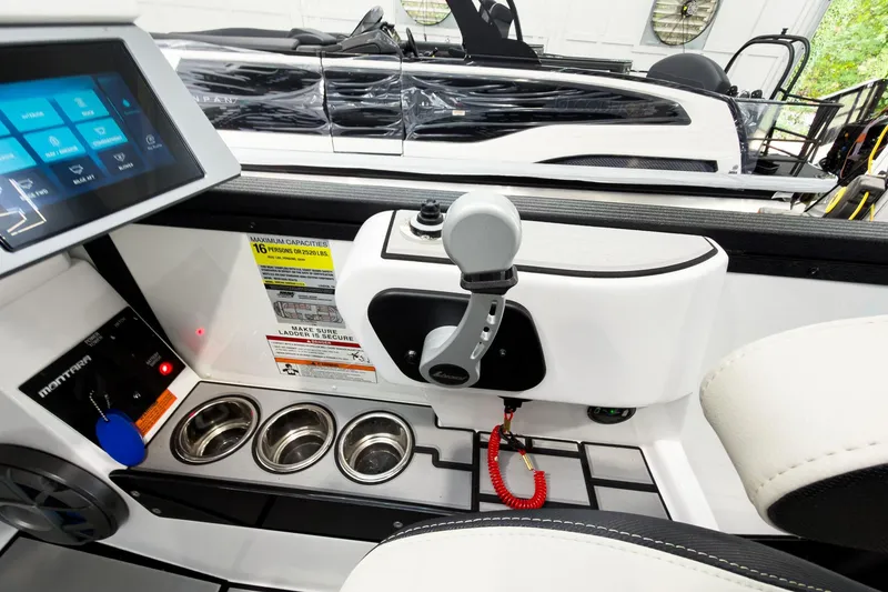 Slide: The Image of Interior of 2025 Montara Surf Boss 2.0 SL 25' boat cockpit with controls and cup holders. - 12