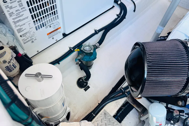 Slide: The Image of Engine room of 2018 Back Cove 37 boat, featuring mechanical components and filters. - 40