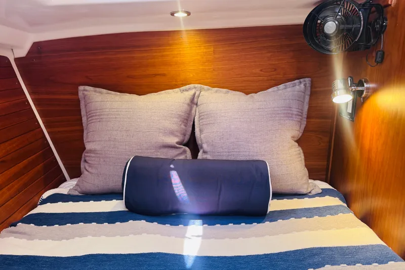 Slide: The Image of Cozy cabin interior of 2018 Back Cove 37 with striped bedding and soft lighting. - 14
