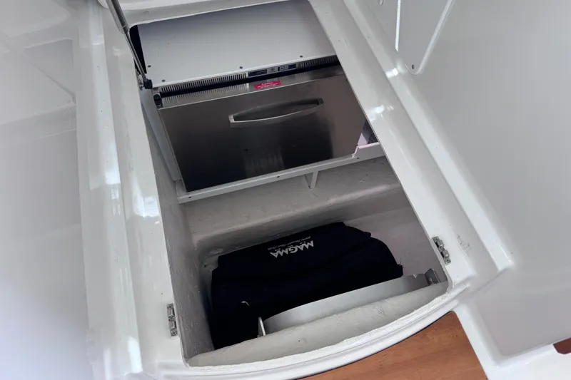 Slide: The Image of Storage compartment with a stainless steel appliance in a 2018 Back Cove 37 boat. - 49
