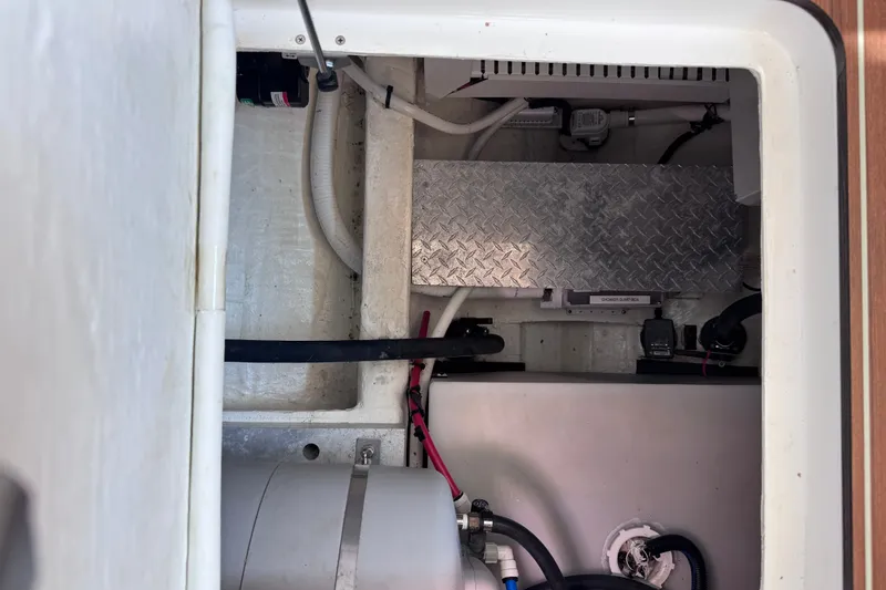 Slide: The Image of Engine compartment of a 2018 Back Cove 37 boat, featuring mechanical components and wiring. - 41