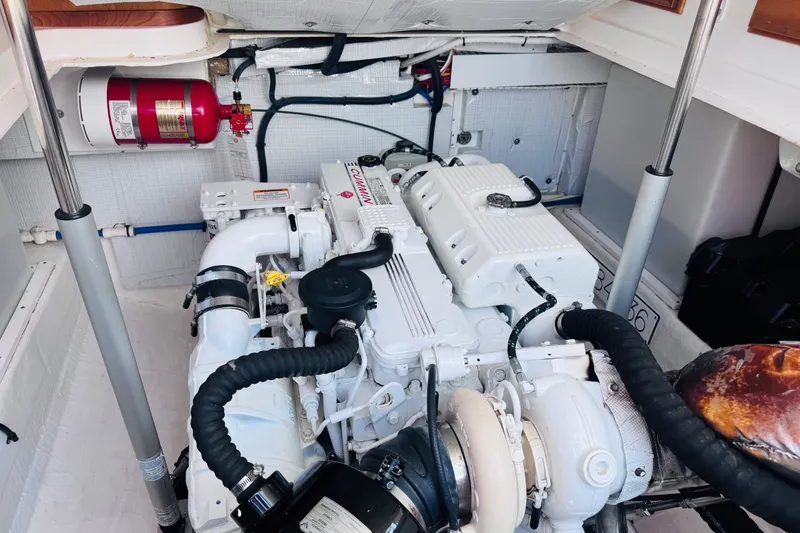 Slide: The Image of Engine room of a 2018 Back Cove 37 boat, featuring a Cummins engine and fire extinguisher. - 36