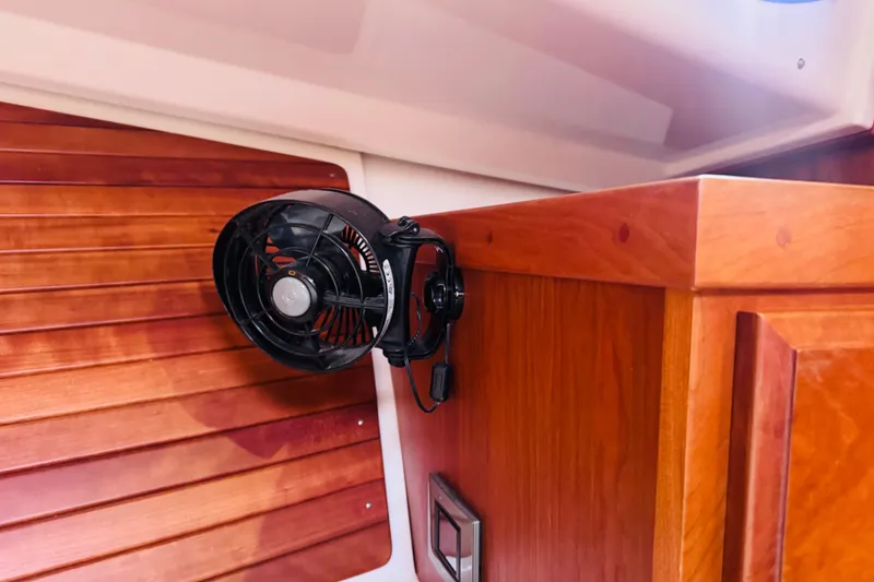 Slide: The Image of Interior of 2018 Back Cove 37 boat with mounted fan and wooden paneling. - 9