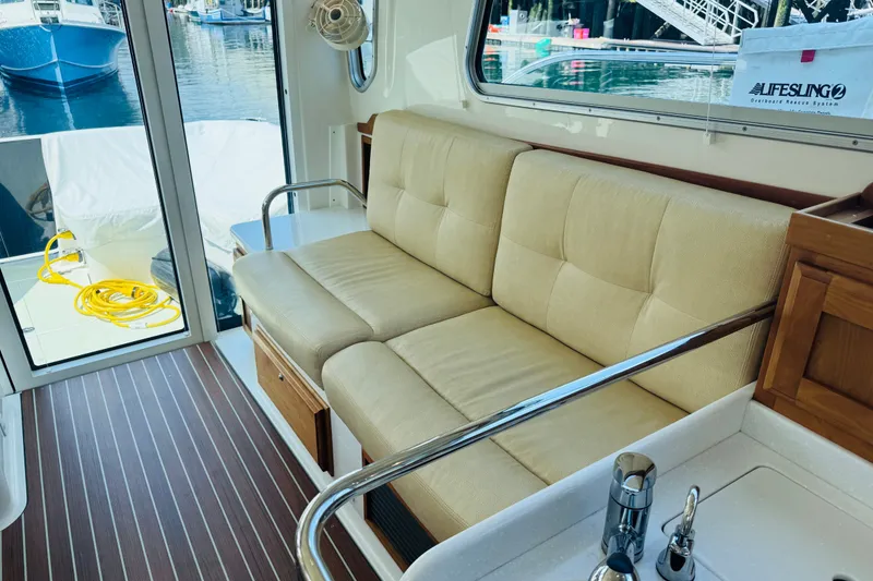 Slide: The Image of Interior of a 2018 Back Cove 37 yacht with beige seating and wooden flooring. - 27