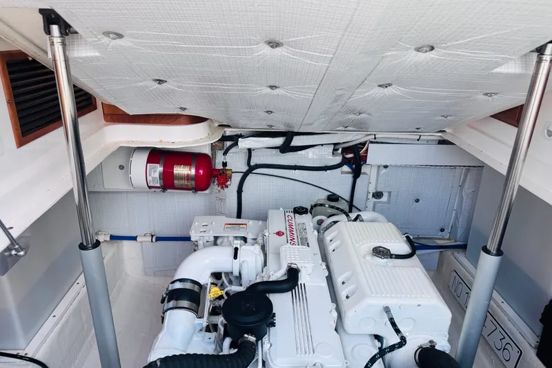 Slide: The Image of Engine room of a 2018 Back Cove 37 boat with Cummins engine and fire extinguisher. - 35