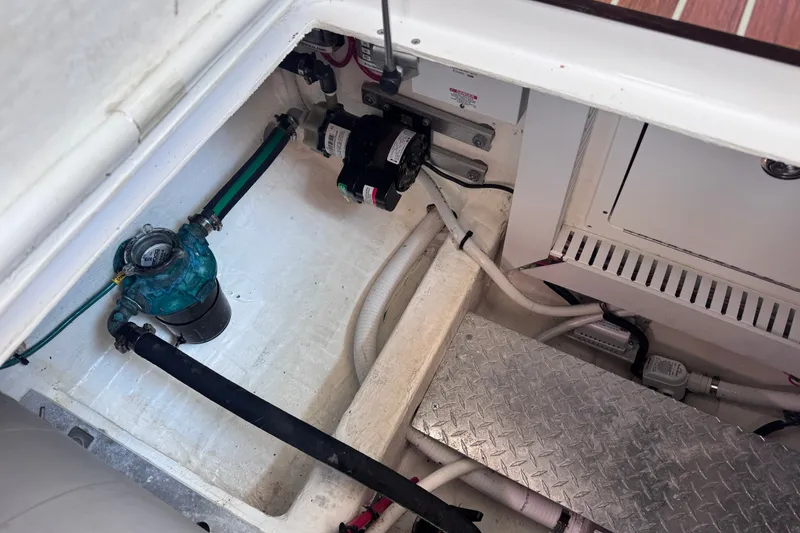 Slide: The Image of Engine compartment of a 2018 Back Cove 37 boat, showing mechanical components and piping. - 42