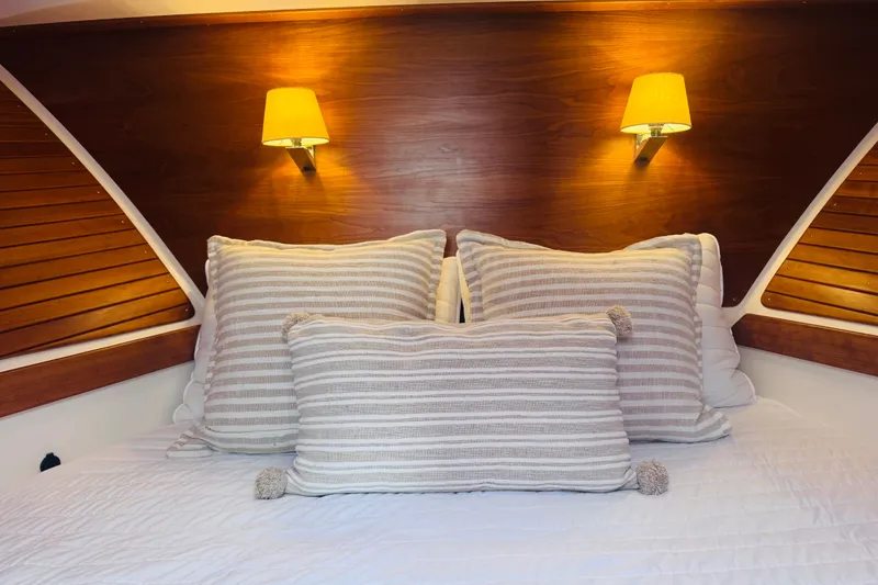 Slide: The Image of Cozy cabin interior of 2018 Back Cove 37 yacht with striped pillows and warm lighting. - 3