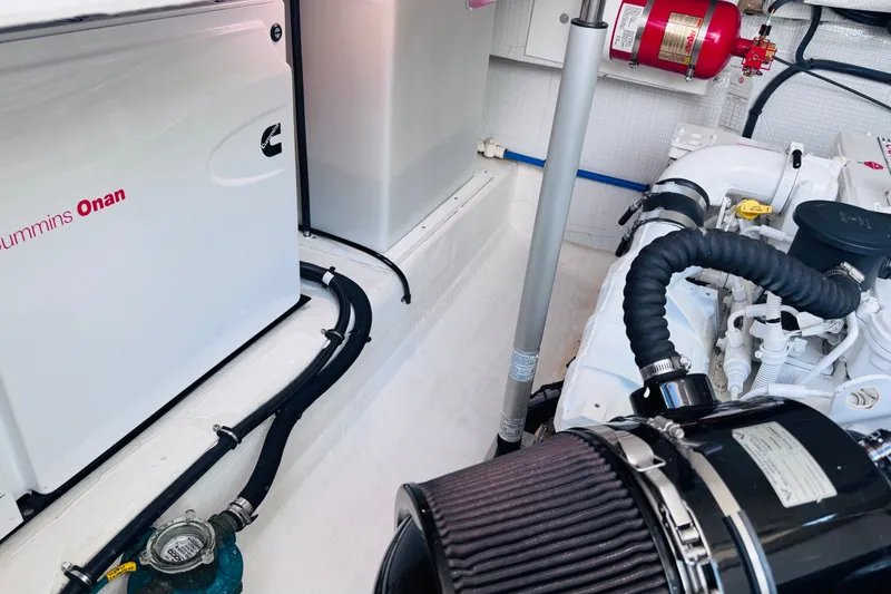 Slide: The Image of Engine room of 2018 Back Cove 37 with Cummins Onan generator and fire extinguisher. - 39