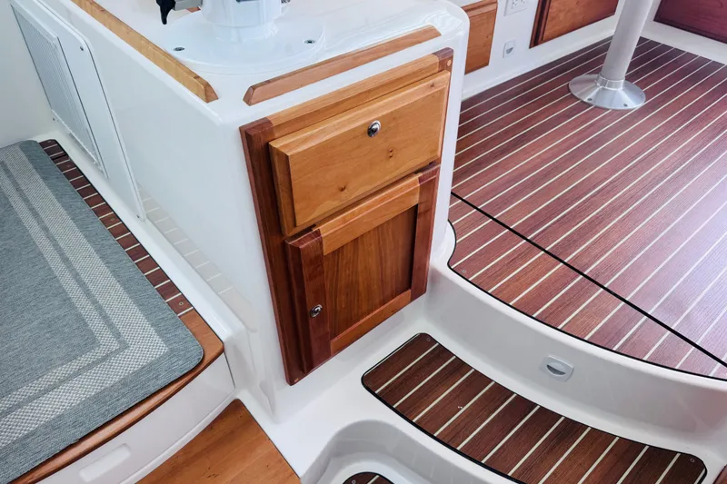 Slide: The Image of 2018 Back Cove 37 interior with wood cabinetry and striped flooring. - 34