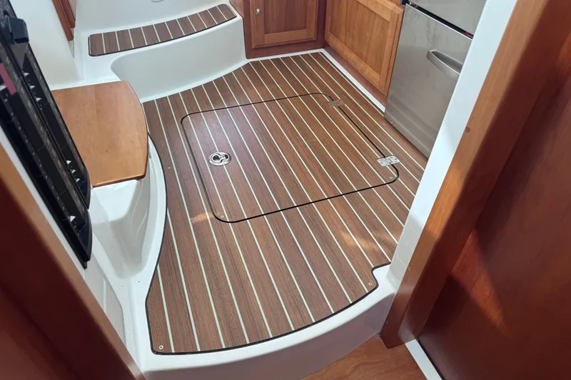 Slide: The Image of 2018 Back Cove 37 interior with wood flooring and cabinetry. - 48