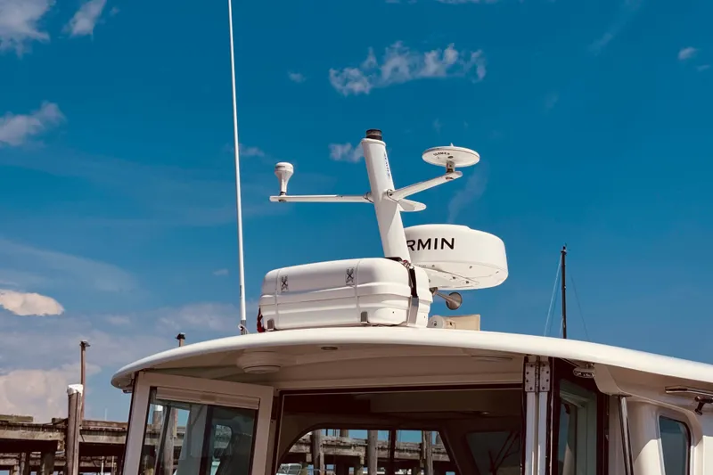 Slide: The Image of 2018 Back Cove 37 boat with Garmin radar against a clear blue sky. - 53