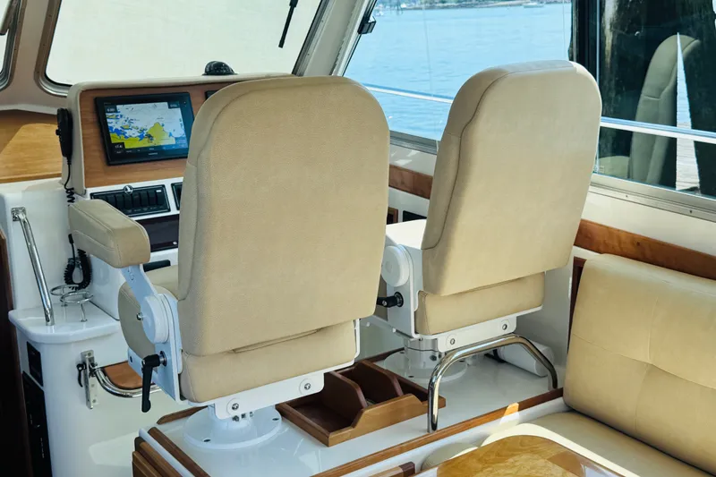 Slide: The Image of Interior helm of 2018 Back Cove 37 boat with beige seats and navigation display. - 33
