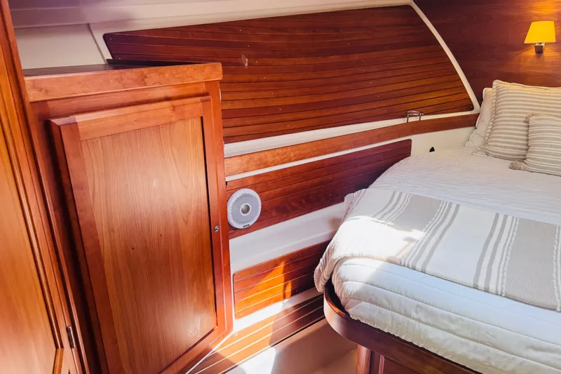 Slide: The Image of Cozy cabin interior of 2018 Back Cove 37 yacht with wooden paneling and bed. - 6