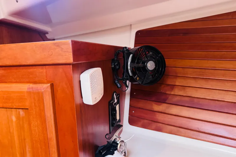 Slide: The Image of 2018 Back Cove 37 interior with wooden cabinetry, fan, and speaker. - 10