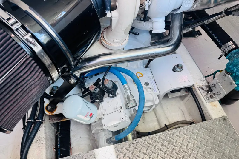 Slide: The Image of Engine compartment of a 2018 Back Cove 37 boat, showcasing mechanical components and piping. - 38