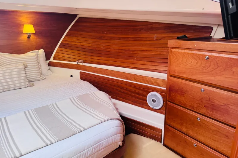 Slide: The Image of Luxurious cabin interior of 2018 Back Cove 37 yacht with wooden paneling and cozy bedding. - 5