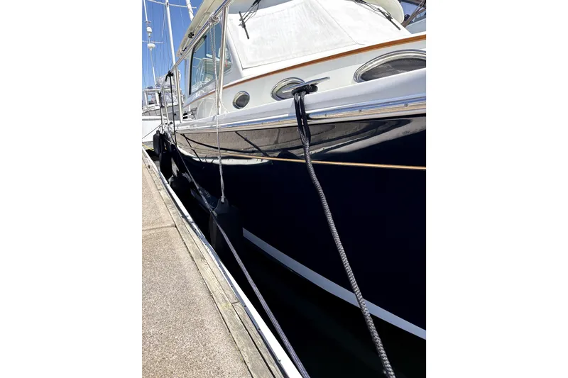 Slide: The Image of 2018 Back Cove 37 yacht docked, showcasing sleek design and polished exterior. - 3