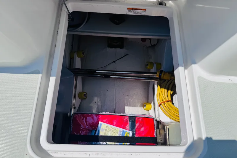 Slide: The Image of Storage compartment on a 2018 Back Cove 37 boat with cables and equipment. - 47