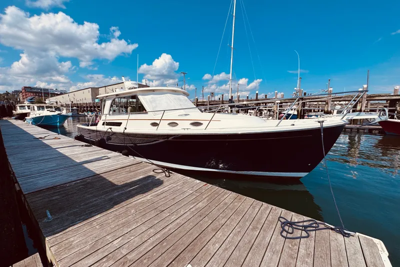 The Image of 2018 Back Cove 37 yacht docked at a marina under a clear blue sky. - 0
