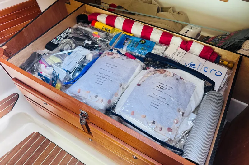 Slide: The Image of Storage compartment on a 2018 Back Cove 37 boat, filled with various supplies and equipment. - 44