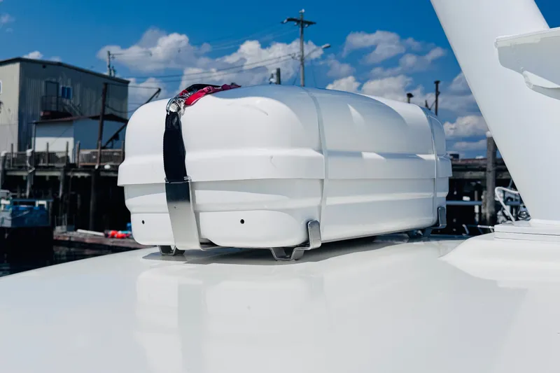 Slide: The Image of White storage container on 2018 Back Cove 37 boat deck, secured with straps. - 54