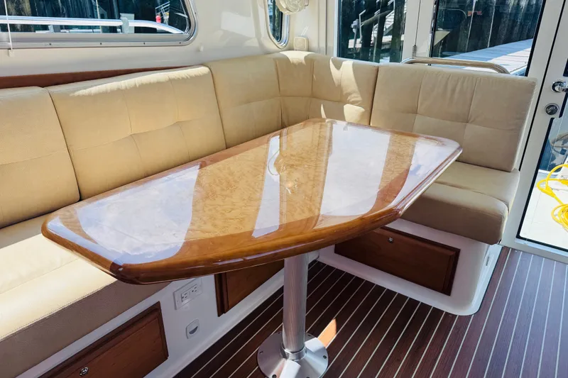 Slide: The Image of Luxurious interior of 2018 Back Cove 37 yacht with polished wood table and cushioned seating. - 26