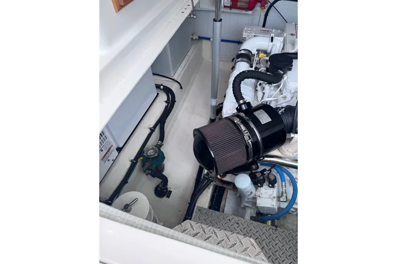 Slide: The Image of Engine compartment of a 2018 Back Cove 37 boat, showcasing mechanical components and systems. - 6