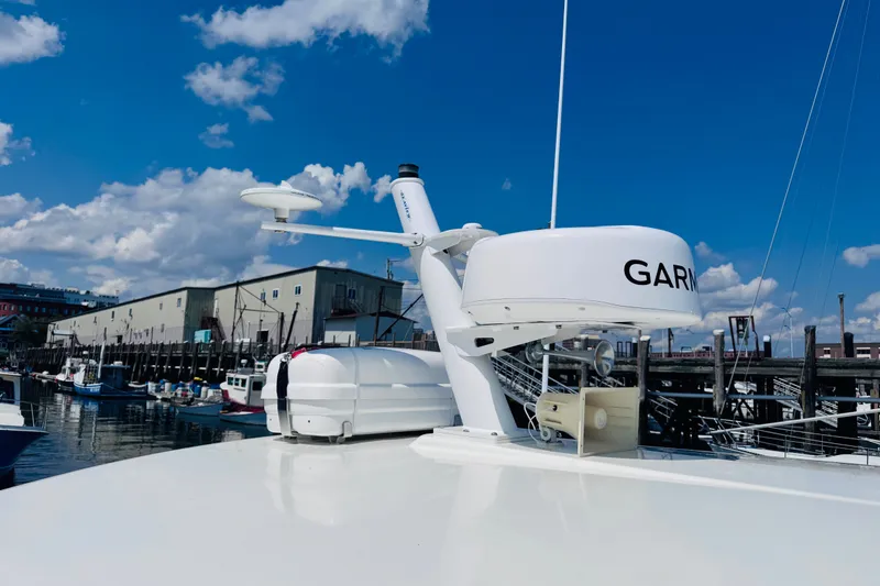 Slide: The Image of 2018 Back Cove 37 boat with Garmin radar, docked under a clear blue sky. - 50