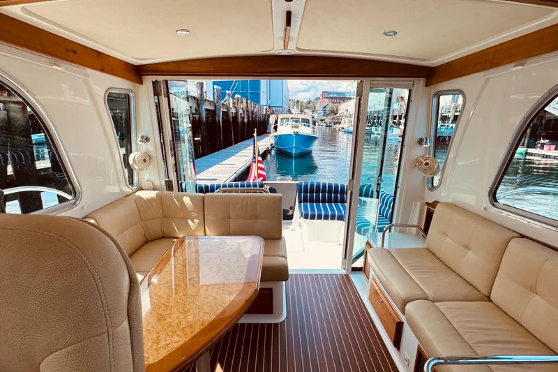 Slide: The Image of Luxurious interior of 2018 Back Cove 37 yacht with elegant seating and waterfront view. - 60