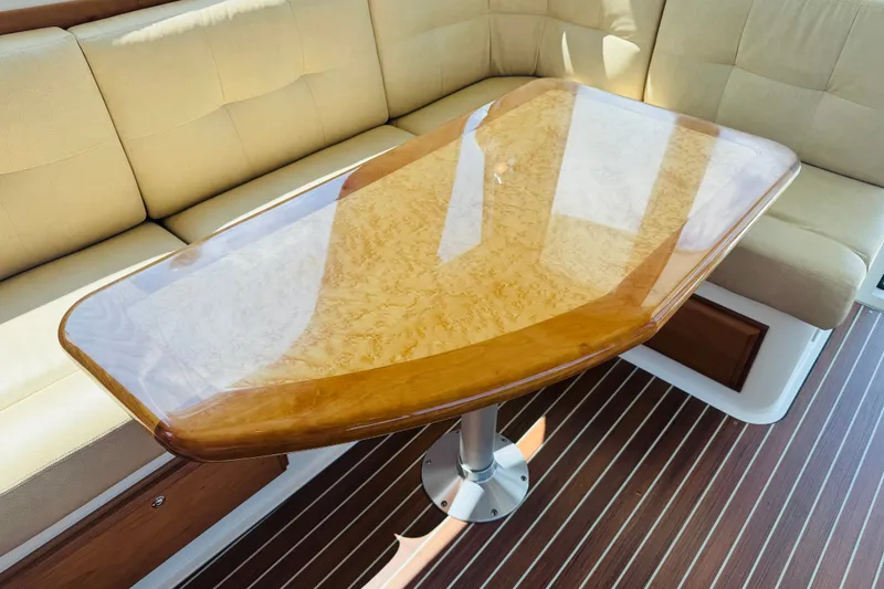 Slide: The Image of Luxurious interior of 2018 Back Cove 37 yacht with polished wooden table and cushioned seating. - 25
