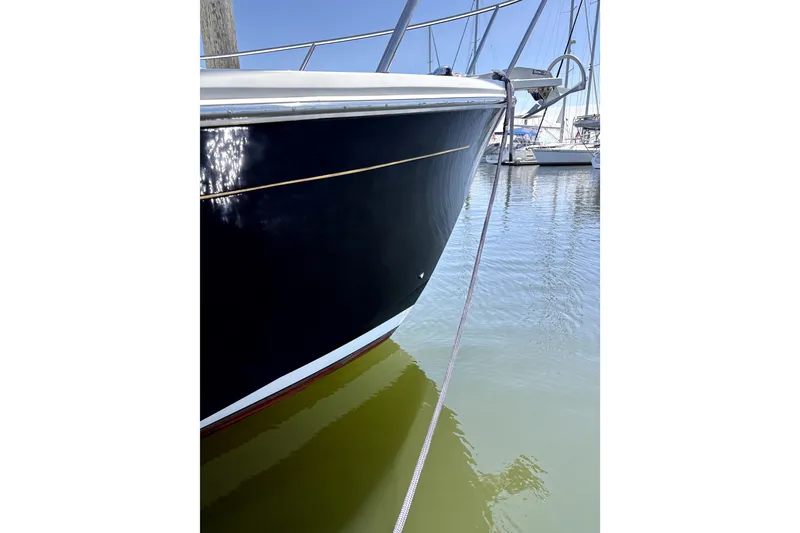 Slide: The Image of 2018 Back Cove 37 boat docked, reflecting sunlight on calm water. - 5