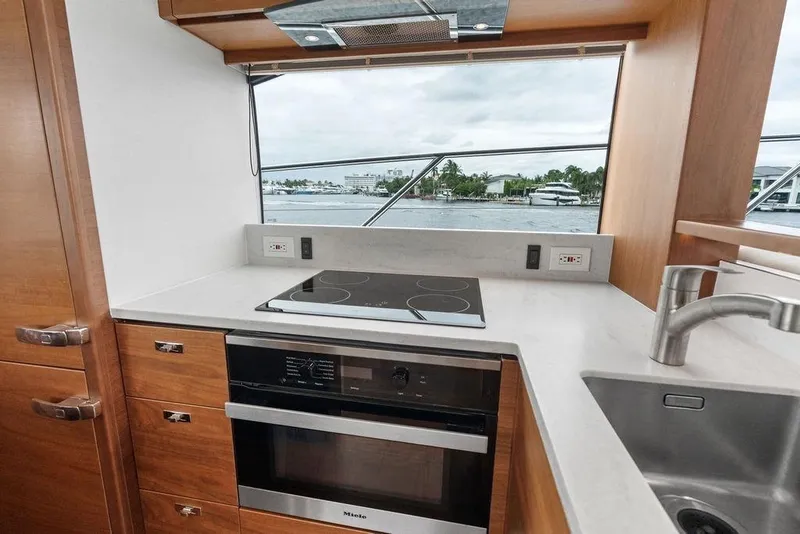 Slide: The Image of Modern yacht kitchen interior with stove, oven, and sink on a 2020 Princess S62. - 40