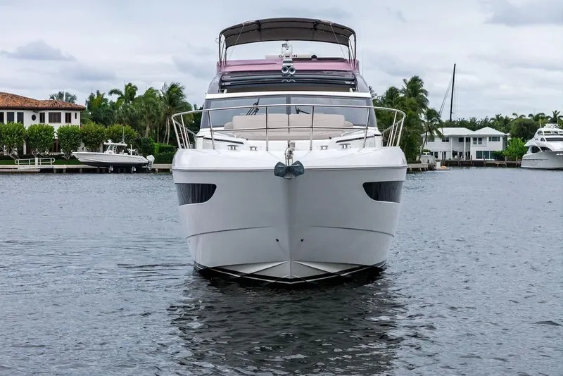 Slide: The Image of Luxury 2020 Princess S62 yacht on calm water, surrounded by waterfront homes. - 3