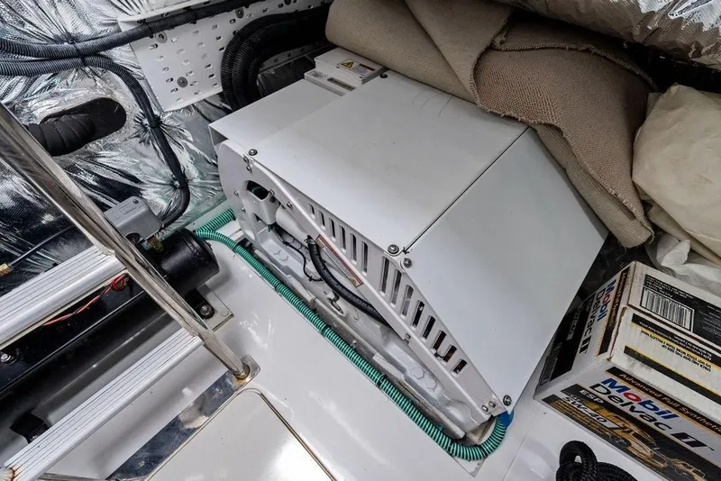Slide: The Image of Engine compartment of 2020 Princess S62 yacht, featuring mechanical components and storage items. - 77