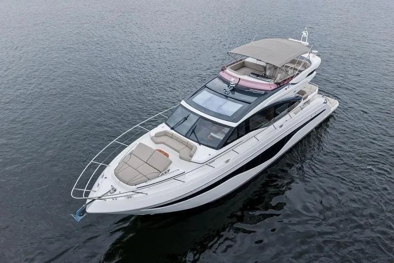 Slide: The Image of 2020 Princess S62 yacht on calm water, featuring sleek design and spacious deck. - 9