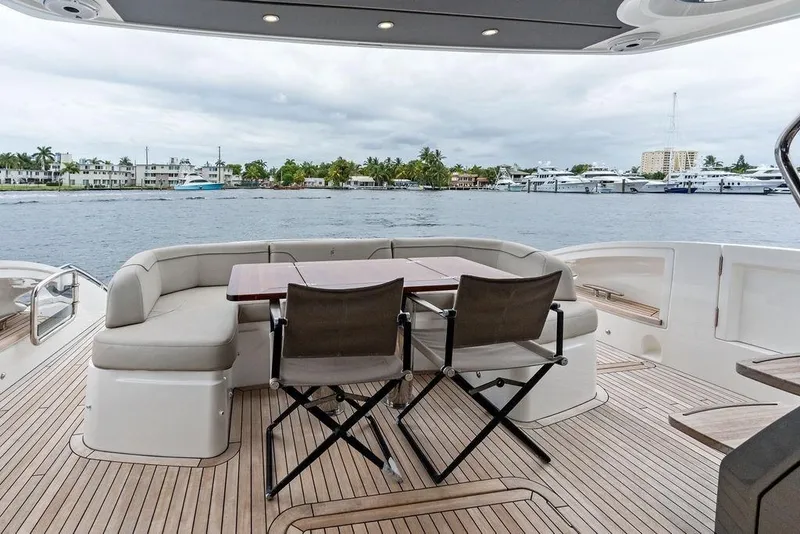 Slide: The Image of Luxurious 2020 Princess S62 yacht deck with seating, overlooking marina and waterfront homes. - 32