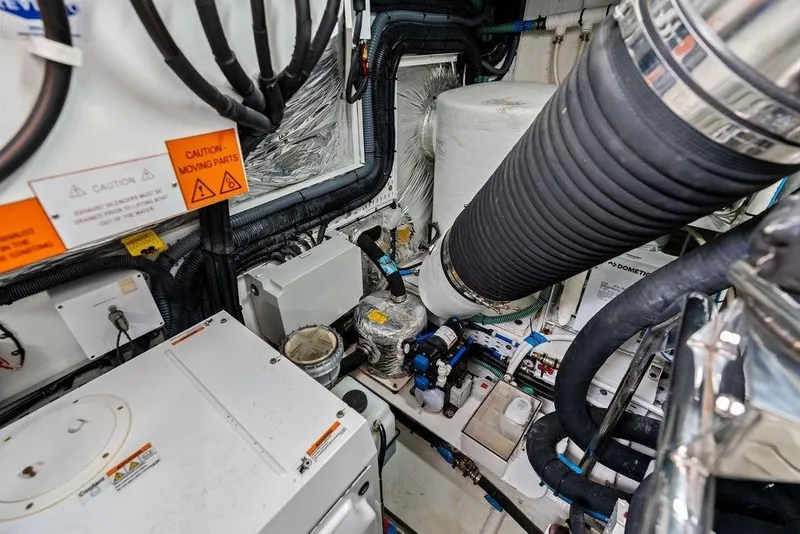 Slide: The Image of Engine room of 2020 Princess S62 yacht with complex machinery and warning signs. - 82