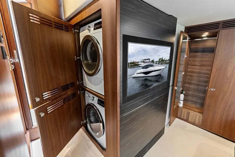 Slide: The Image of Laundry area inside a 2020 Princess S62 yacht, featuring modern appliances and sleek wood cabinetry. - 50