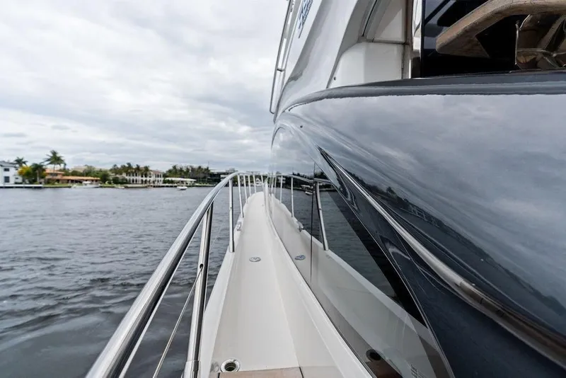Slide: The Image of Side view of a 2020 Princess S62 yacht on a calm waterway. - 11