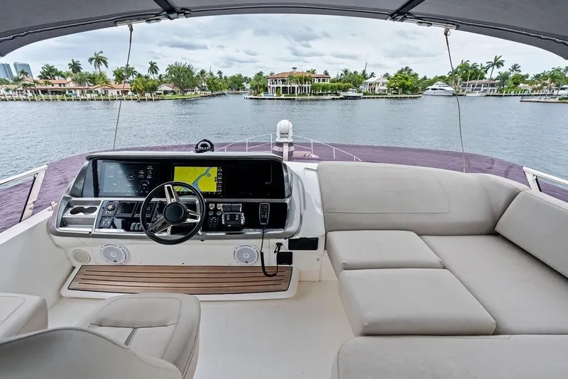 Slide: The Image of Luxurious 2020 Princess S62 yacht helm with plush seating and scenic waterfront view. - 22