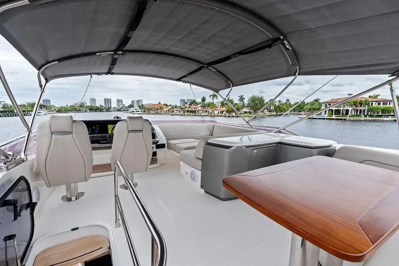 Slide: The Image of Luxurious 2020 Princess S62 yacht interior with seating, table, and waterfront view. - 16