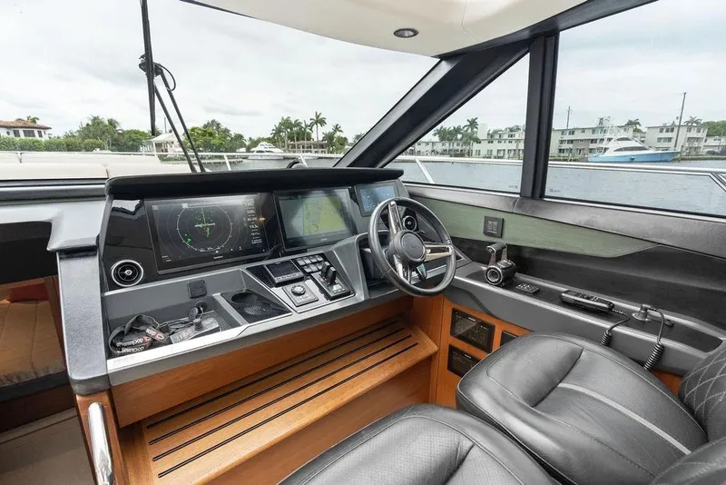 Slide: The Image of Interior of 2020 Princess S62 yacht cockpit with modern navigation controls and leather seating. - 46
