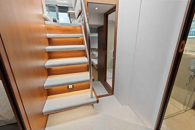 Slide: The Image of Interior of 2020 Princess S62 yacht featuring elegant staircase and modern design elements. - 49