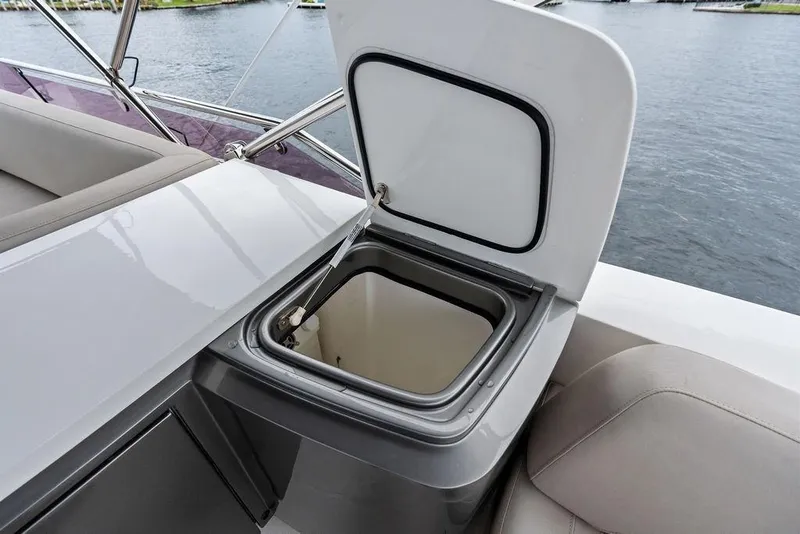 Slide: The Image of Open storage compartment on 2020 Princess S62 yacht, with water view in background. - 20