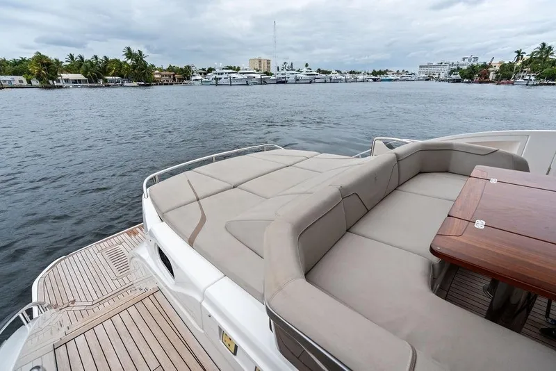 Slide: The Image of Luxurious 2020 Princess S62 yacht deck with seating and table, overlooking a serene waterfront. - 30