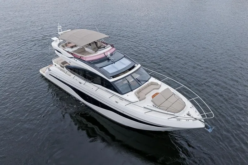 Slide: The Image of Luxury 2020 Princess S62 yacht cruising on open water, showcasing sleek design and spacious deck. - 8