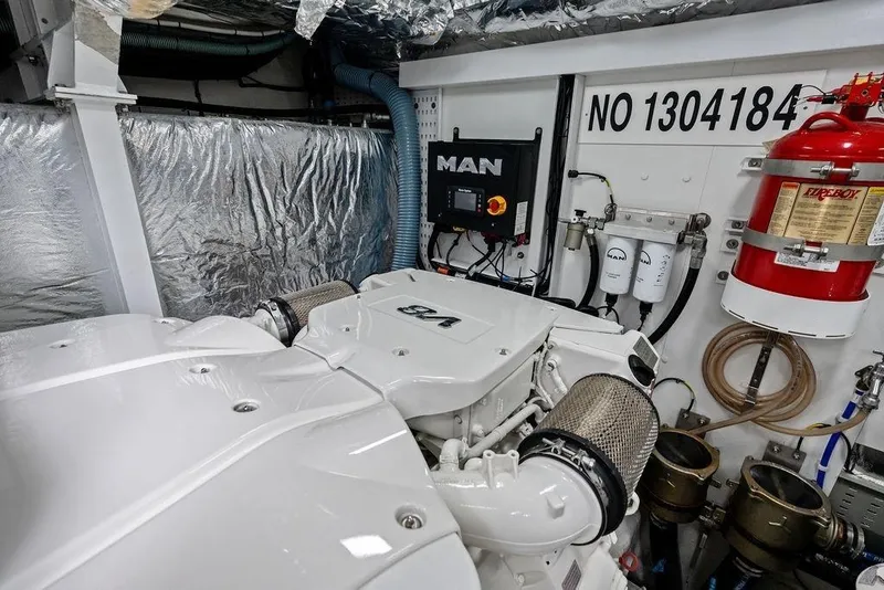 Slide: The Image of Engine room of a 2020 Princess S62 yacht featuring a MAN engine and fire suppression system. - 76