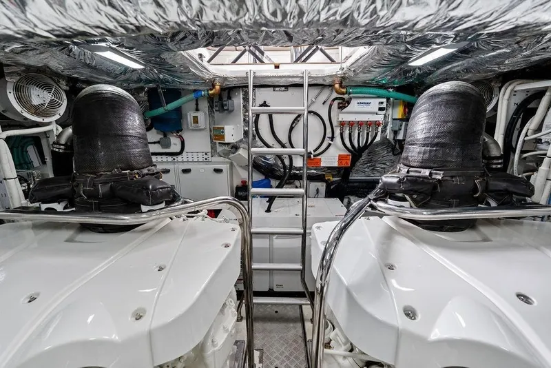 Slide: The Image of Engine room of a 2020 Princess S62 yacht, featuring dual engines and technical equipment. - 72