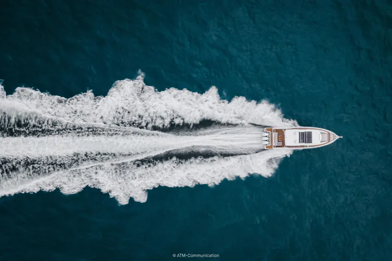 Slide: The Image of Aerial view of 2026 Wellcraft 44 Explorer yacht cruising on blue ocean waters. - 25